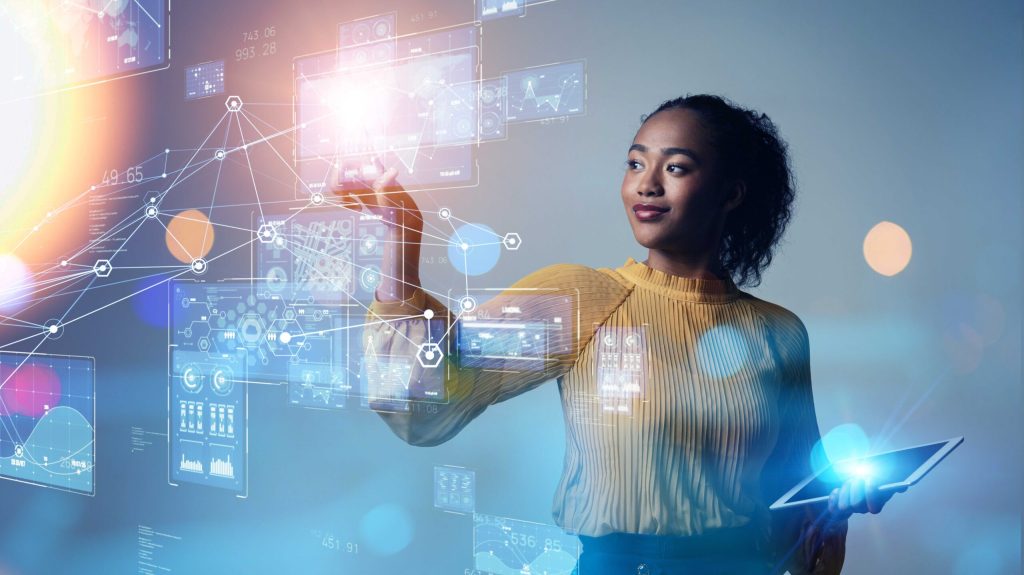 Woman holding a tablet and working on hologram screen