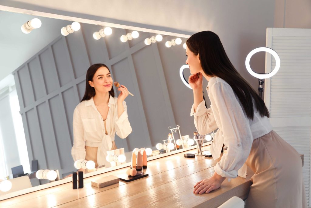 Woman doing make up in the mirror