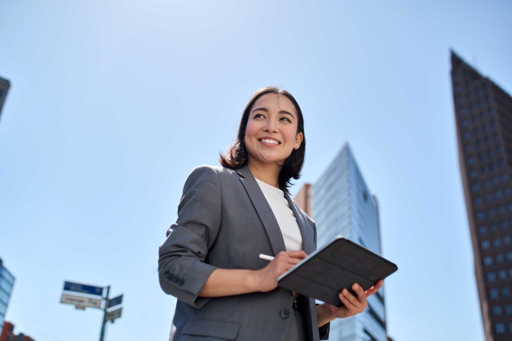 Woman smiling holding her pen and tablet