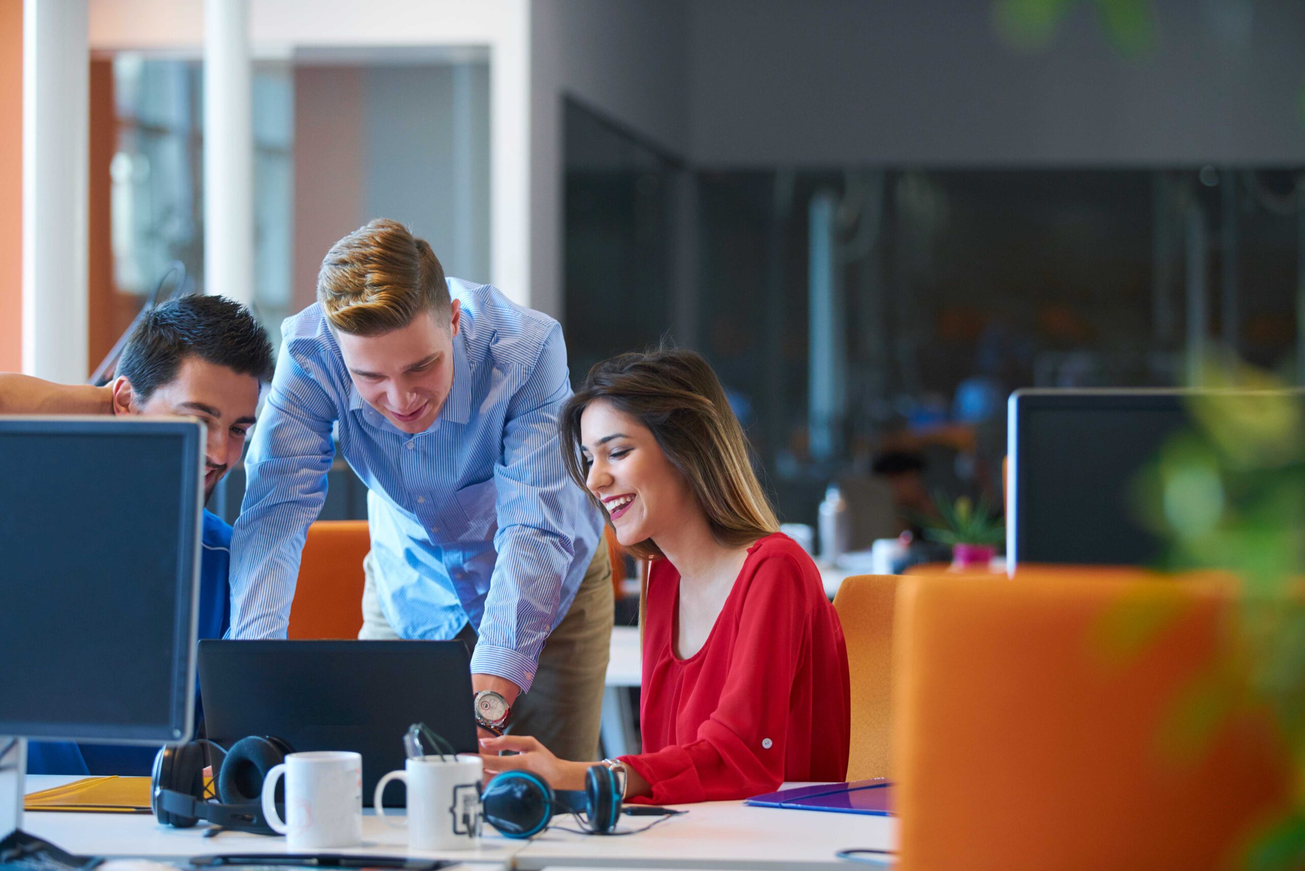 man and woman happily working in the laptop