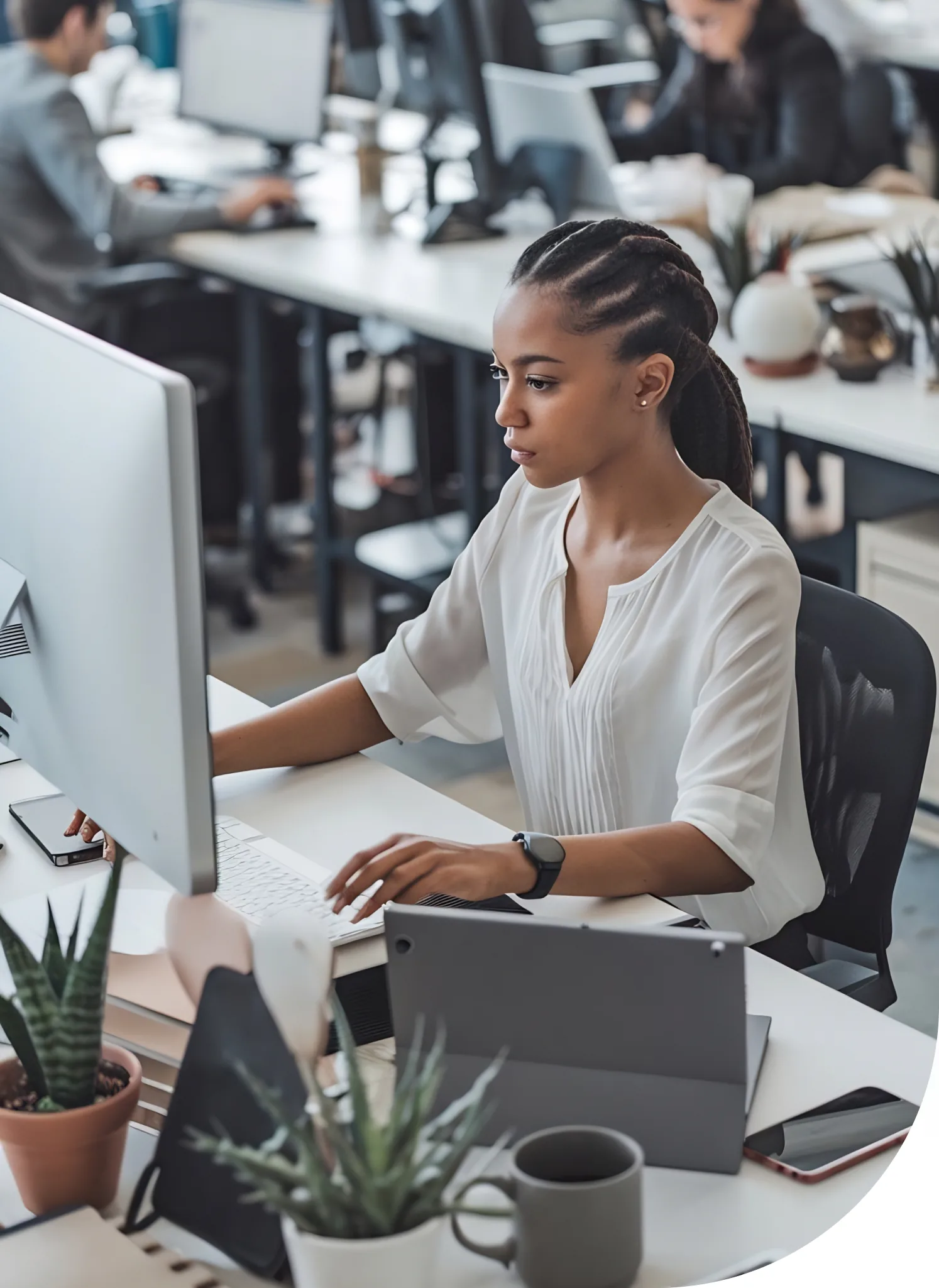 Professional working at a desk with a laptop in a modern office