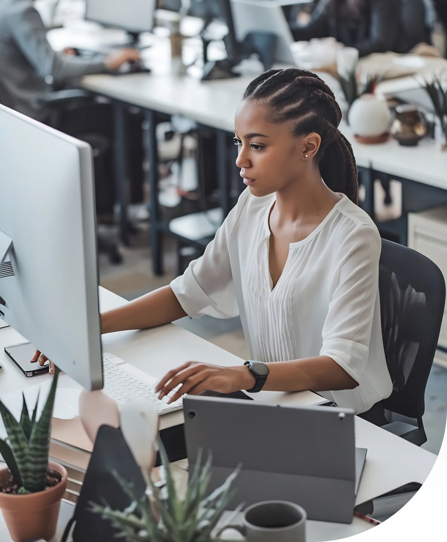 Professional working at a desk with a laptop in a modern office