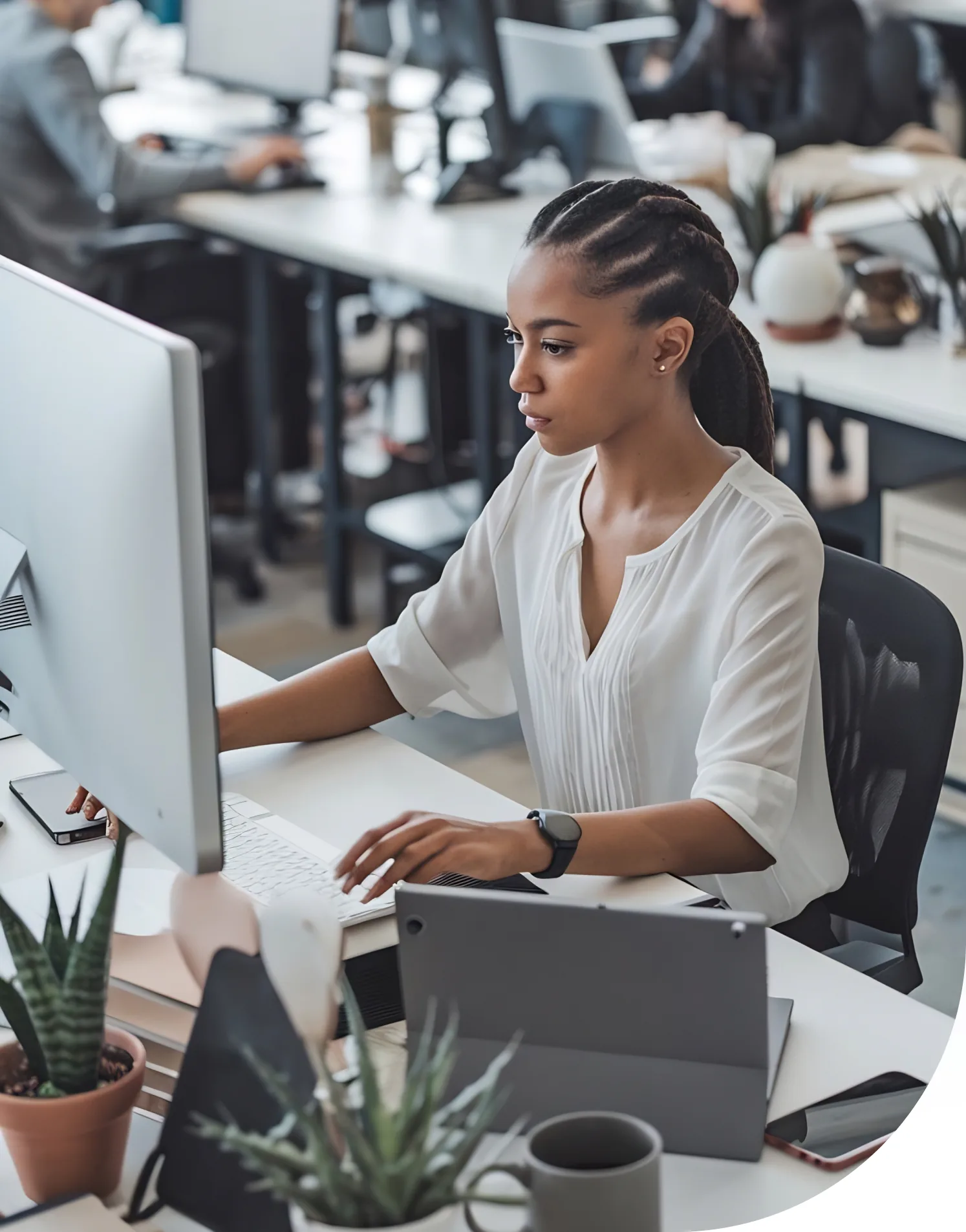 Professional working at a laptop in a modern office